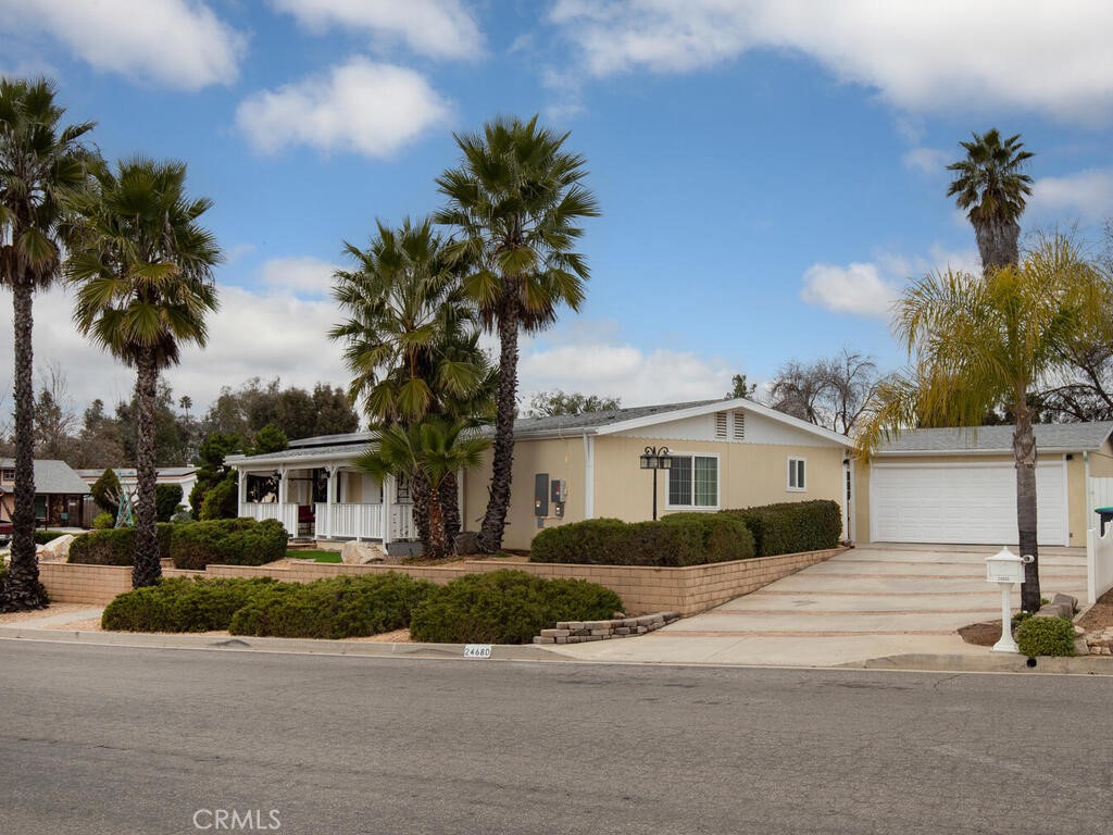 24680 Butterchurn Road Wildomar, CA 92595 - Photo 1 of 1 Side of house with view of garage and driveway.