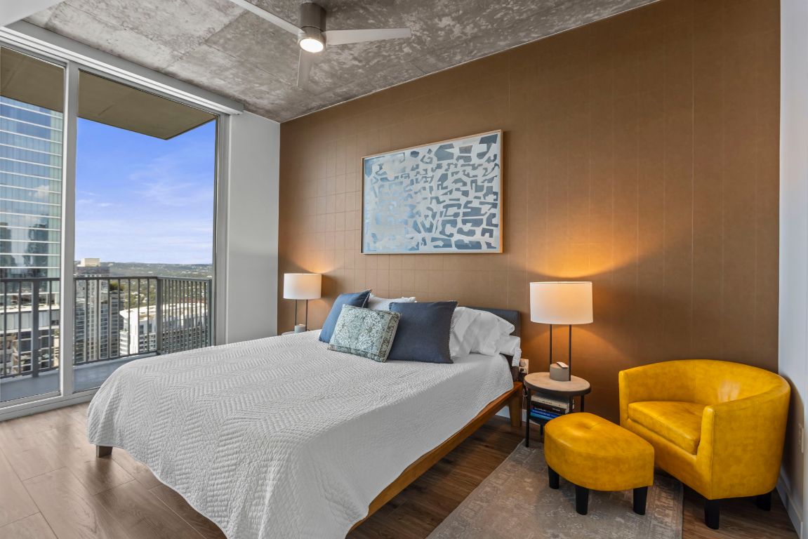 360 Nueces Street, Unit 3904 Austin, TX 78701 - Photo 11 of 32 a bedroom with a bed and lamp