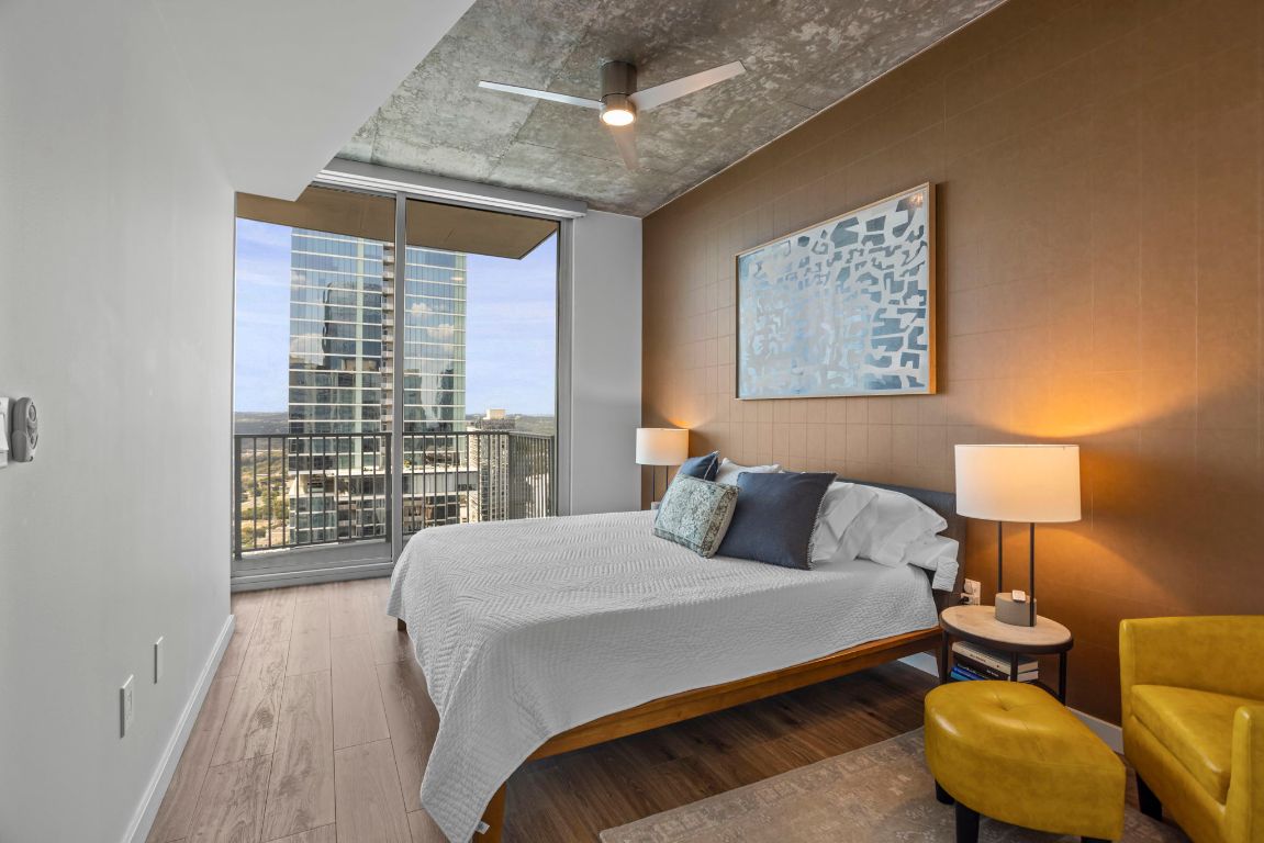 360 Nueces Street, Unit 3904 Austin, TX 78701 - Photo 13 of 32 a bedroom with a bed and a night stand