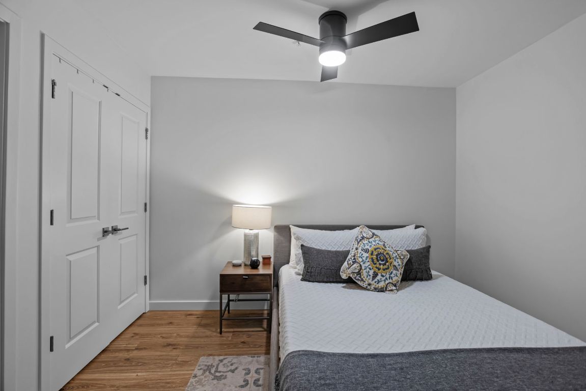 360 Nueces Street, Unit 3904 Austin, TX 78701 - Photo 17 of 32 a bedroom with a bed and a table in it