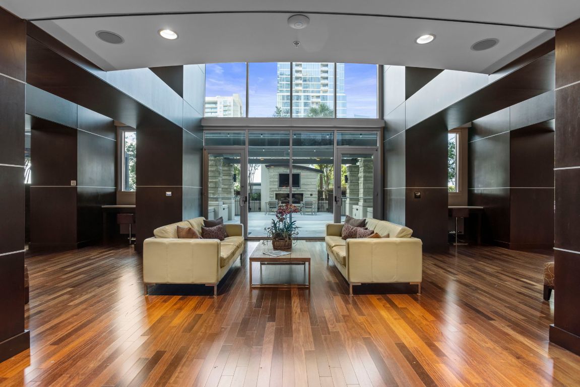 360 Nueces Street, Unit 3904 Austin, TX 78701 - Photo 24 of 32 a living room with furniture and a wooden floor