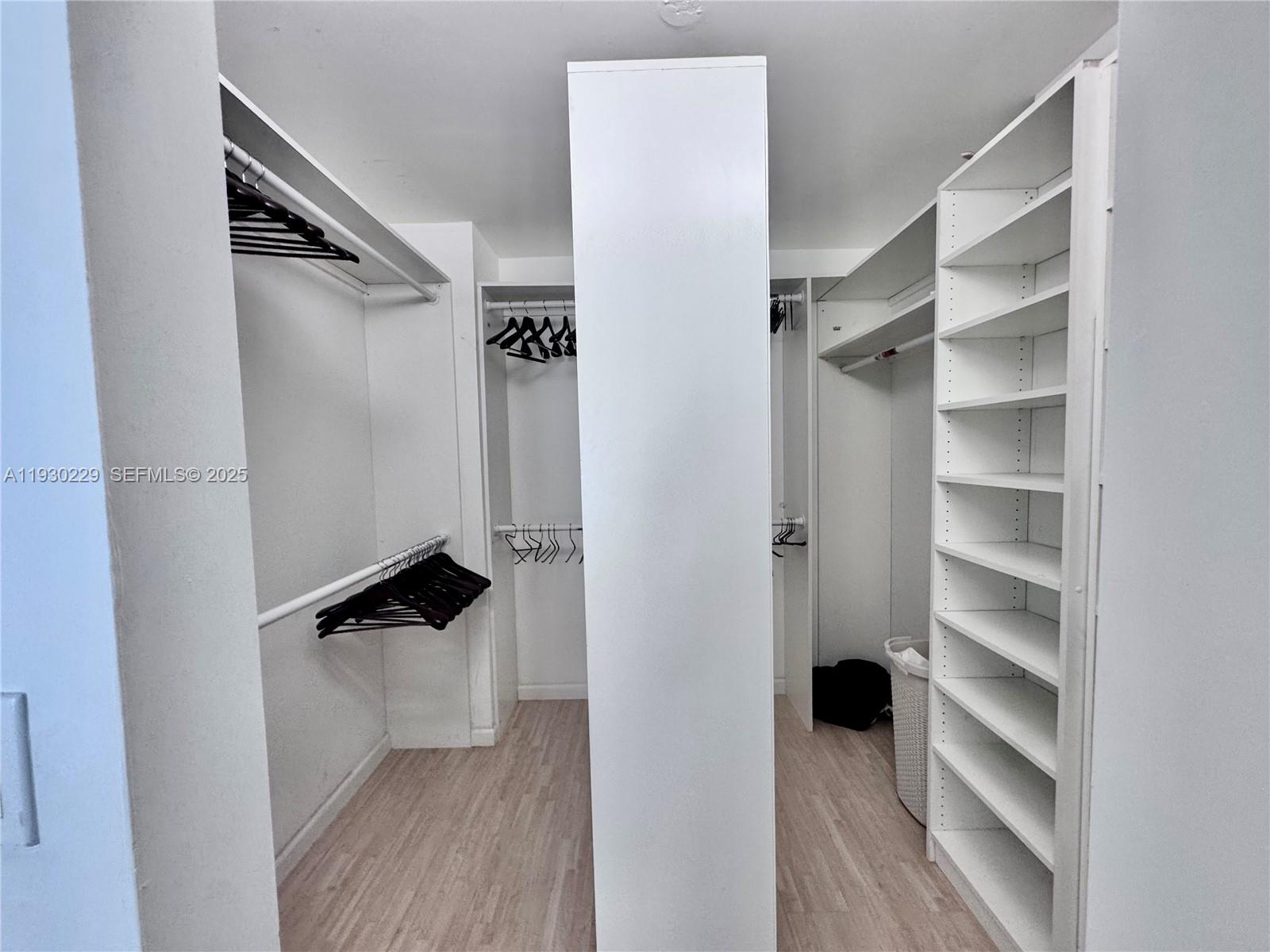 8877 Collins Avenue, Unit 402 Surfside, FL 33154 - Photo 11 of 24 a view of walk in closet with empty racks