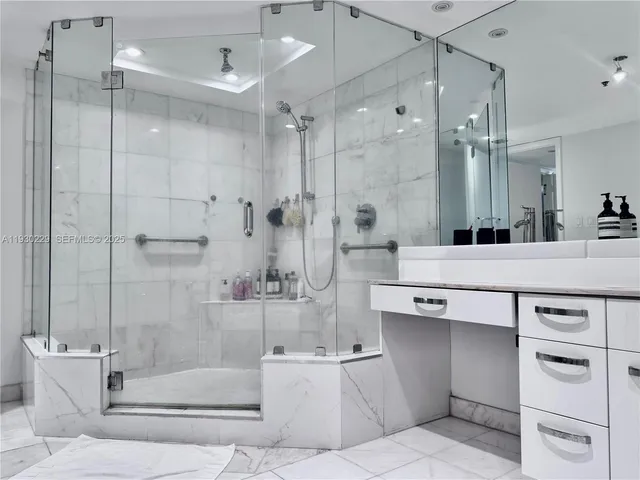 a bathroom with a bathtub shower sink vanity and toilet
