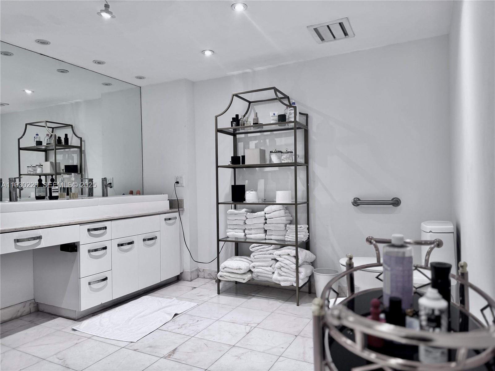 8877 Collins Avenue, Unit 402 Surfside, FL 33154 - Photo 13 of 24 a kitchen with sink and stove