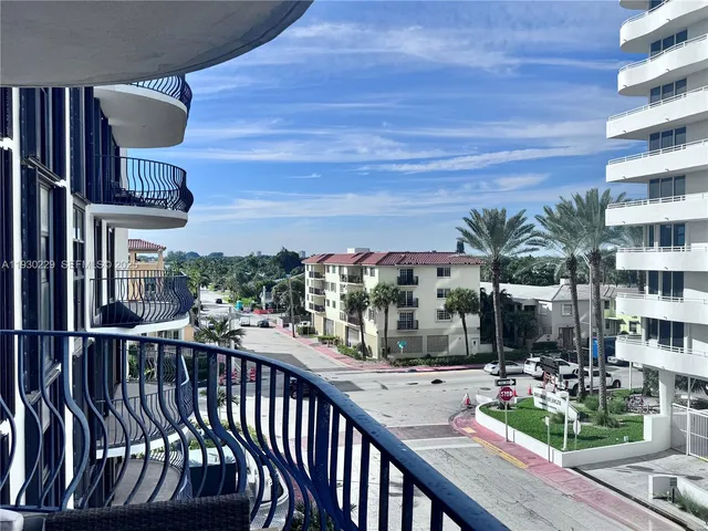a view of a balcony with chairs
