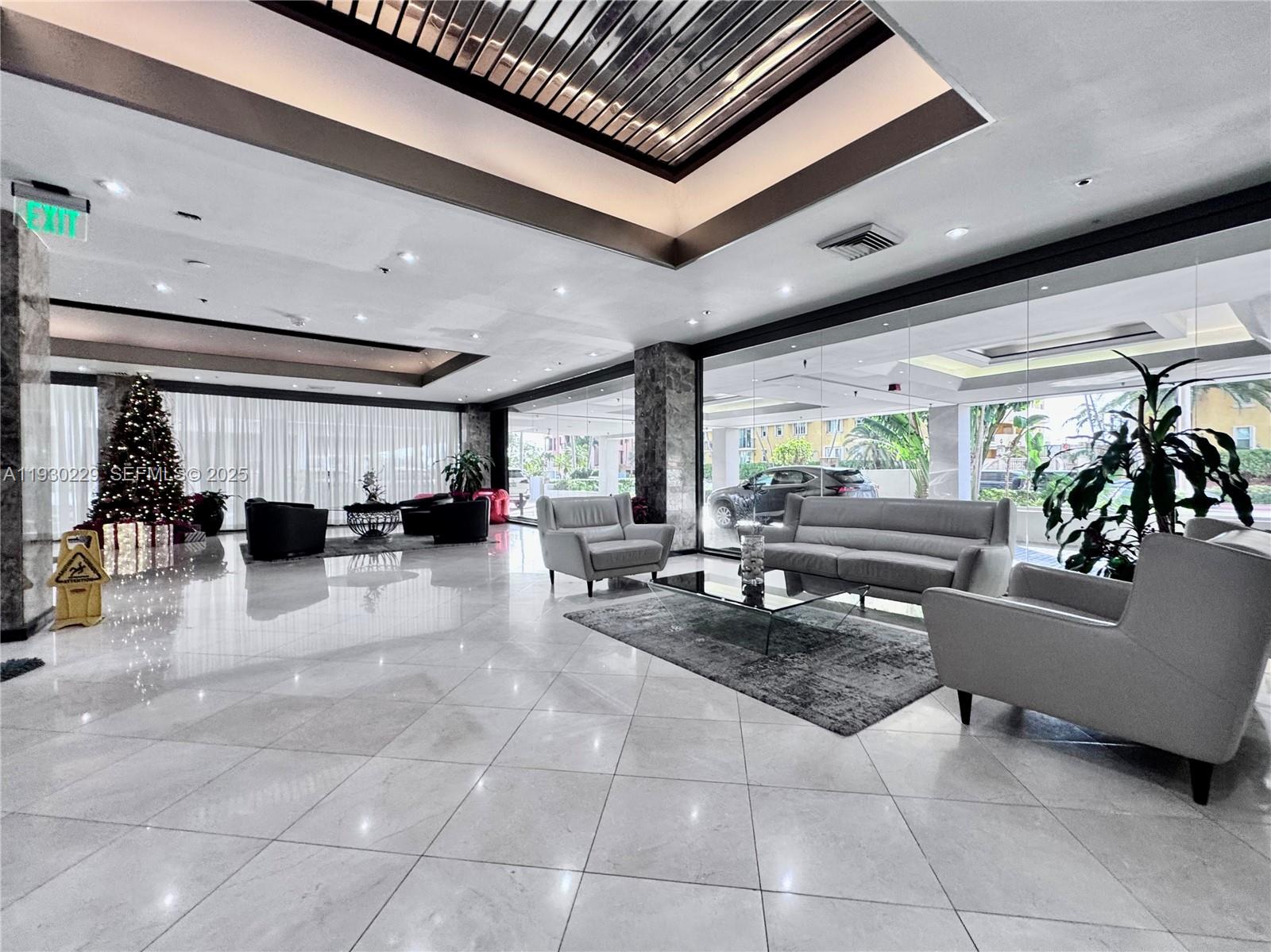 8877 Collins Avenue, Unit 402 Surfside, FL 33154 - Photo 19 of 24 a living room with furniture and a table