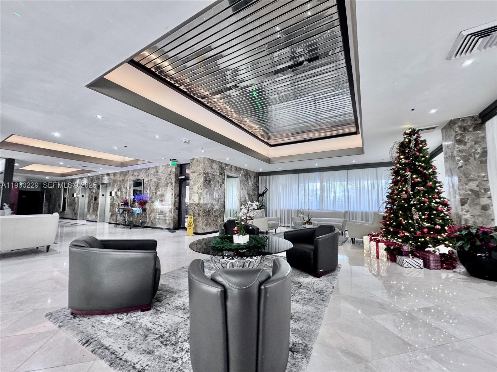 8877 Collins Avenue, Unit 402 Surfside, FL 33154 - Photo 20 of 24 a living room with furniture and a large window