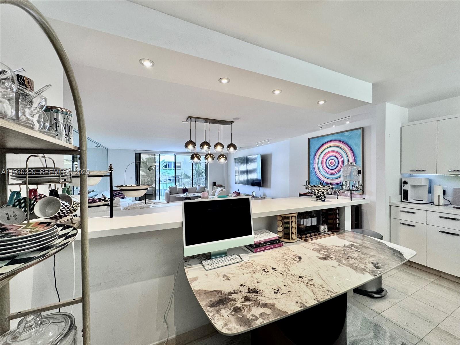 8877 Collins Avenue, Unit 402 Surfside, FL 33154 - Photo 3 of 24 a living room with stainless steel appliances kitchen island granite countertop furniture a rug and a view of kitchen