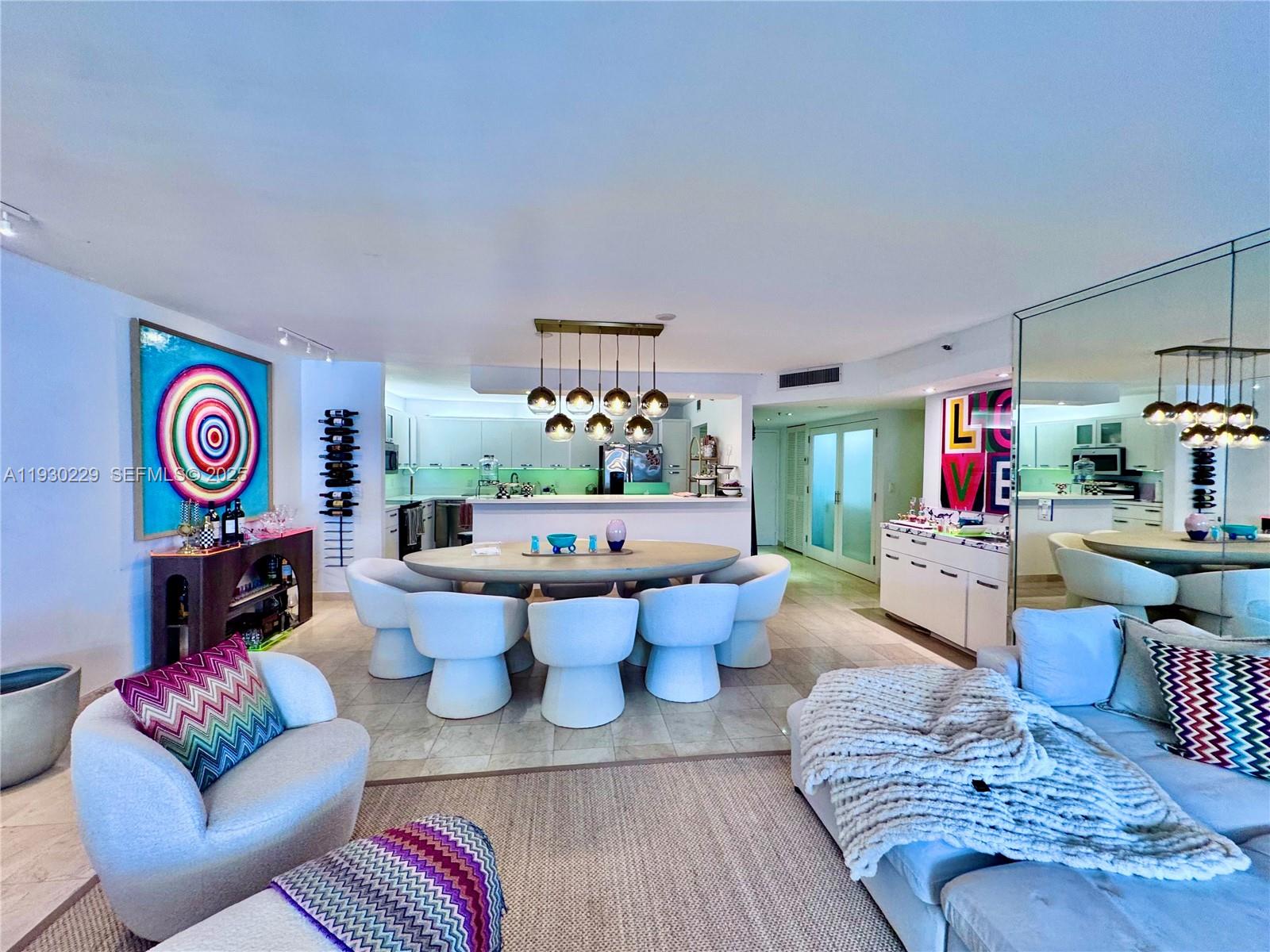 8877 Collins Avenue, Unit 402 Surfside, FL 33154 - Photo 5 of 24 a living room with furniture and a table