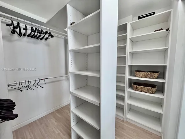 a view of walk in closet with empty racks