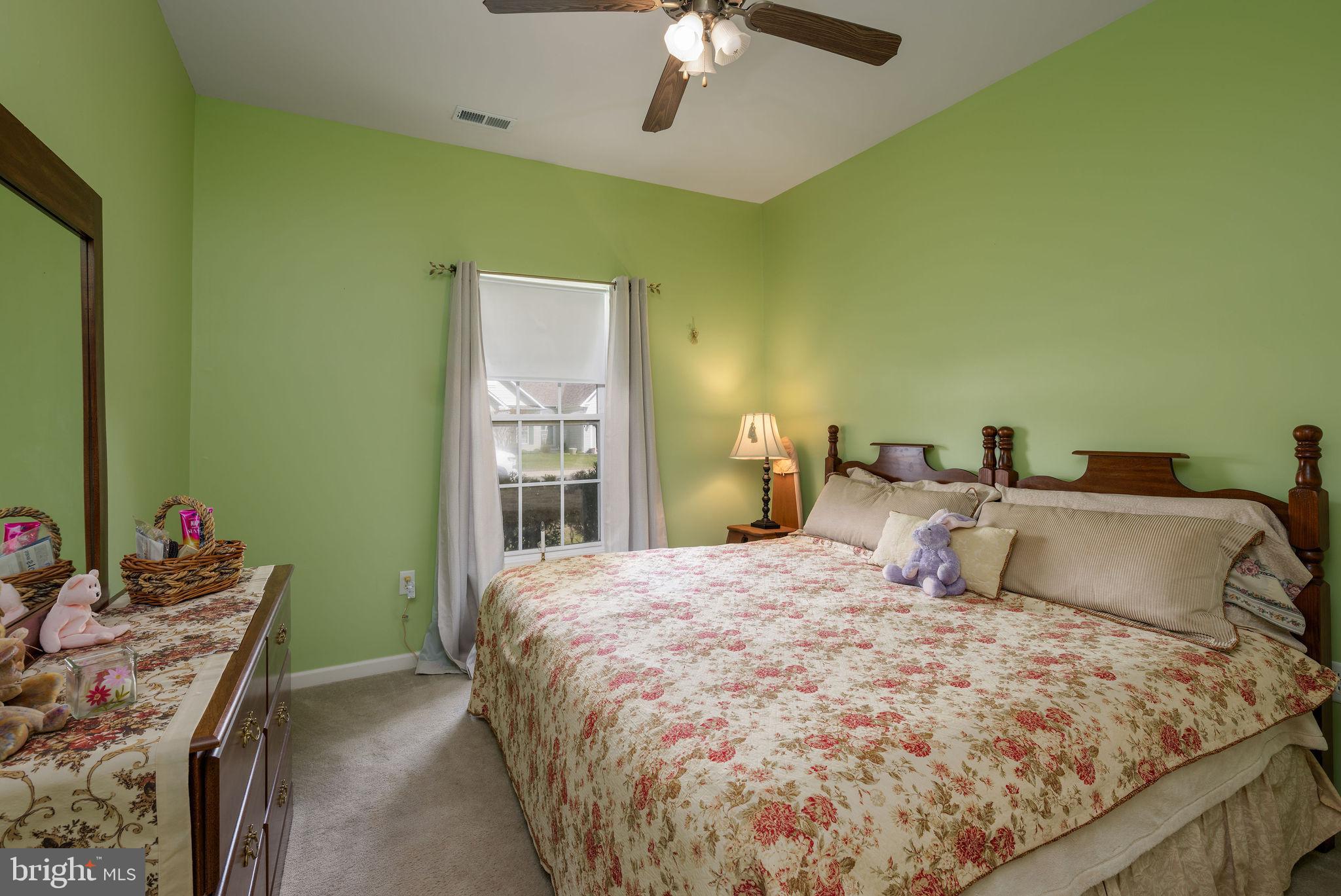 10 Arrowood Knobs Lewes, DE 19958 - Photo 17 of 40 a bedroom with a bed and a chandelier