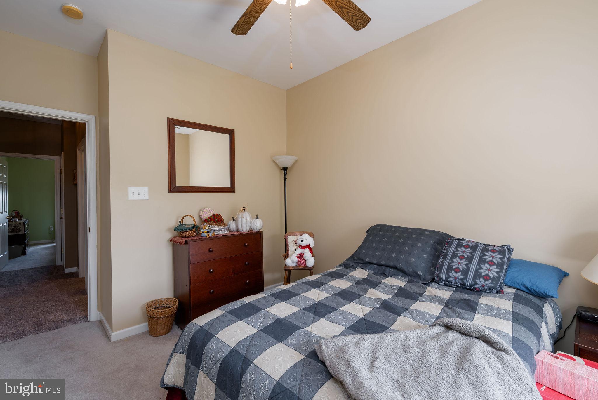 10 Arrowood Knobs Lewes, DE 19958 - Photo 21 of 40 a bedroom with a bed and a chandelier