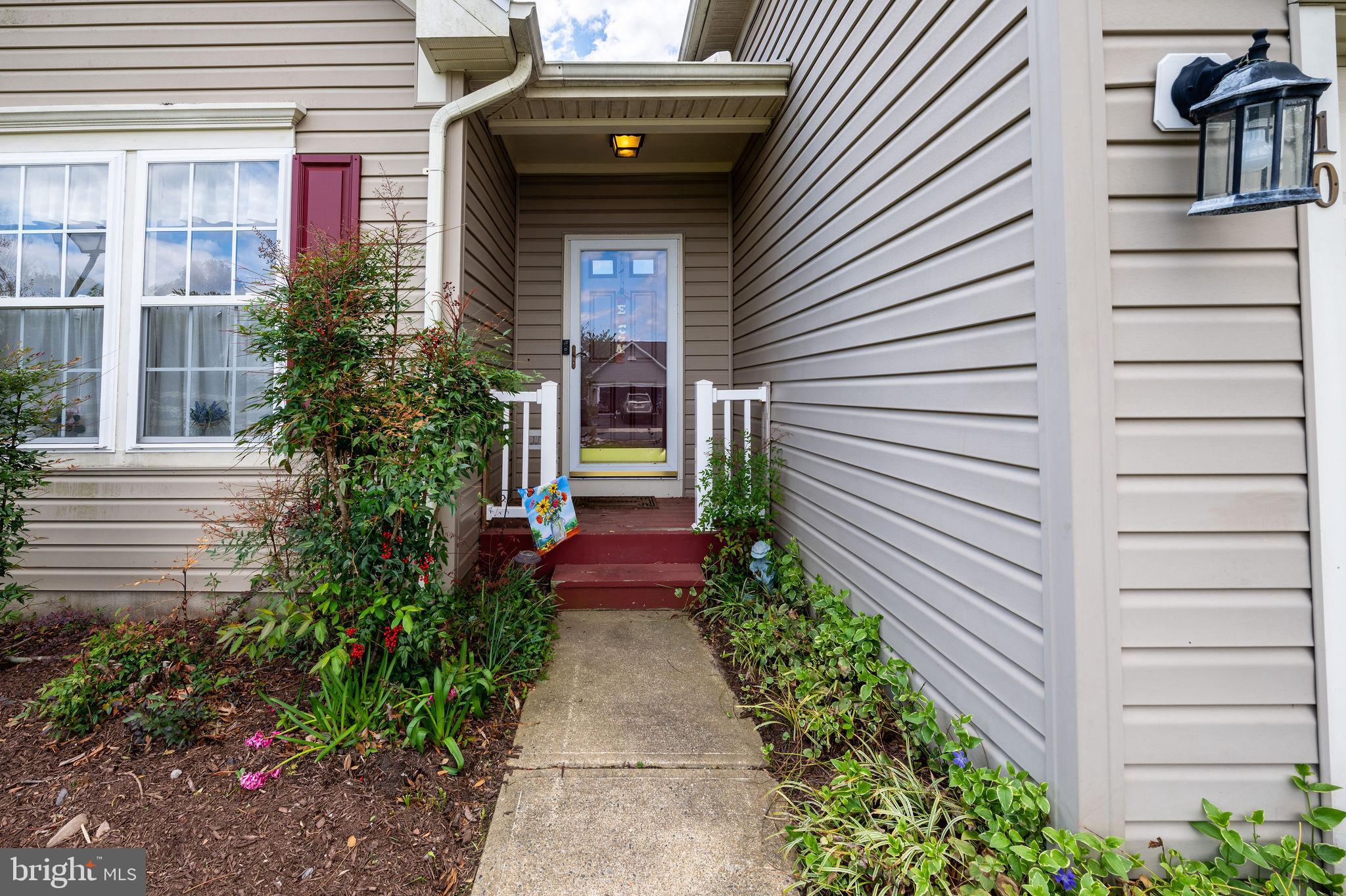 10 Arrowood Knobs Lewes, DE 19958 - Photo 3 of 40 a view of a pathway of the house with potted plants
