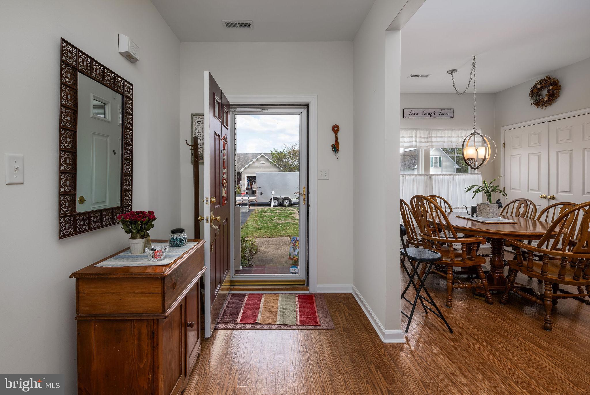 10 Arrowood Knobs Lewes, DE 19958 - Photo 4 of 40 a view of a dining room with furniture and wooden floor