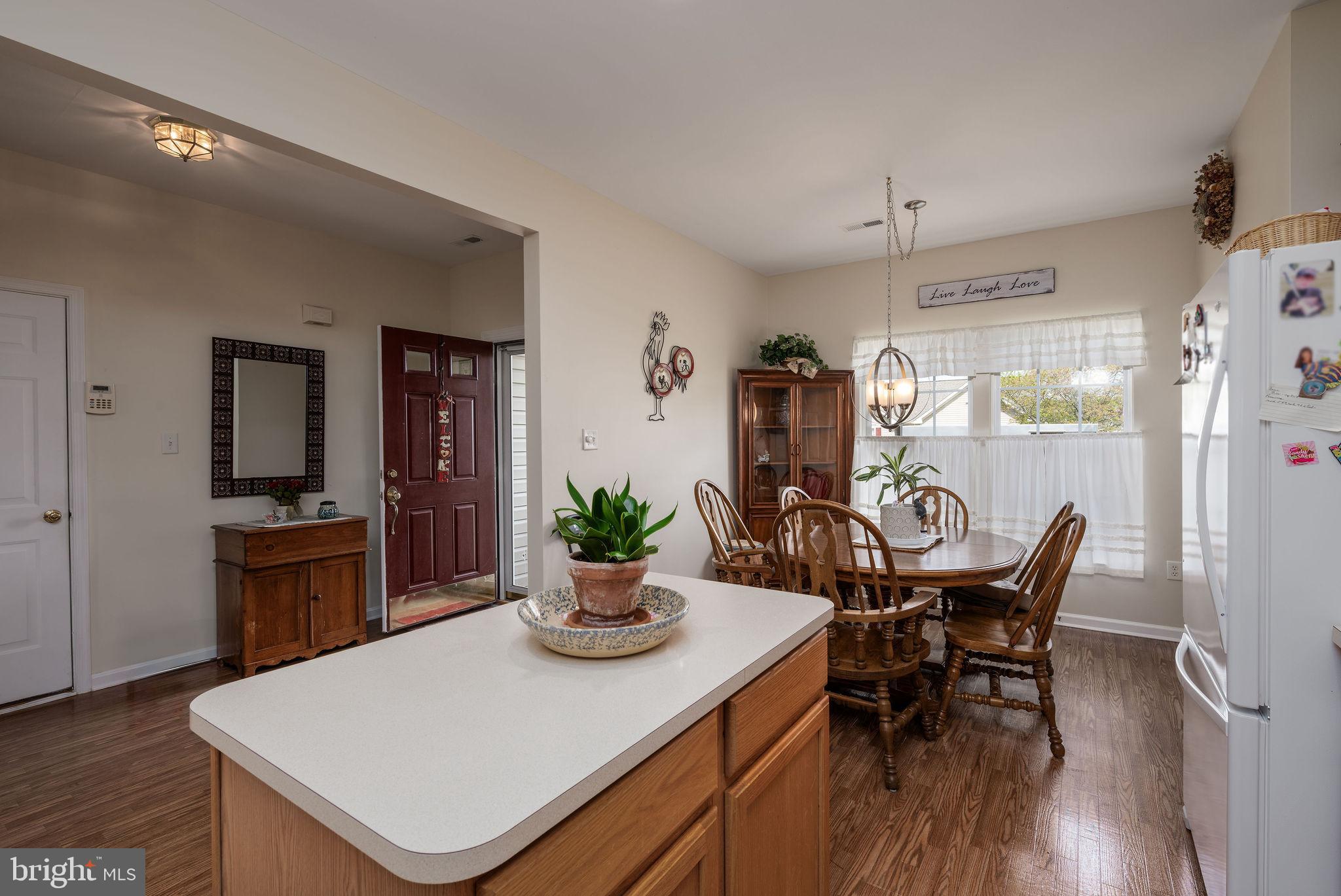 10 Arrowood Knobs Lewes, DE 19958 - Photo 6 of 40 a view of a dining room with furniture and wooden floor