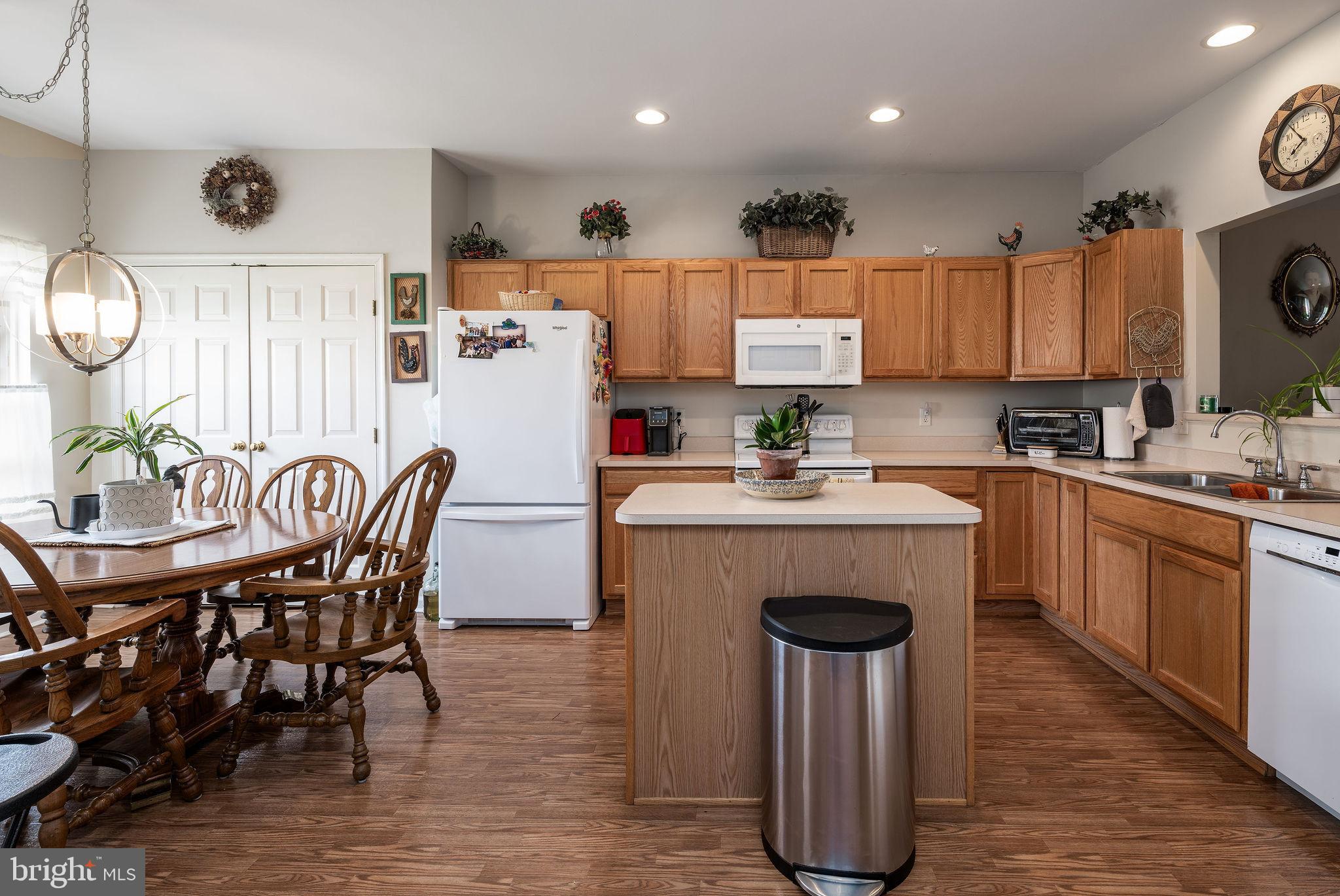 10 Arrowood Knobs Lewes, DE 19958 - Photo 7 of 40 a kitchen with stainless steel appliances granite countertop a table chairs sink refrigerator and microwave