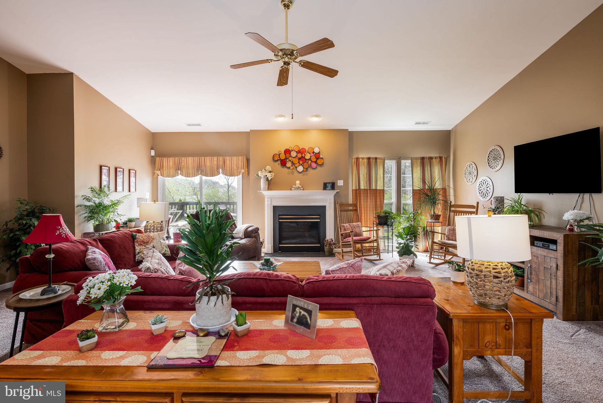 10 Arrowood Knobs Lewes, DE 19958 - Photo 10 of 40 a living room with furniture a fireplace and a flat screen tv