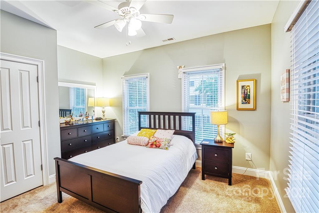 1183 Springmaid Avenue Fort Mill, SC 29708 - Photo 11 of 31 a bed room with a bed and a chandelier