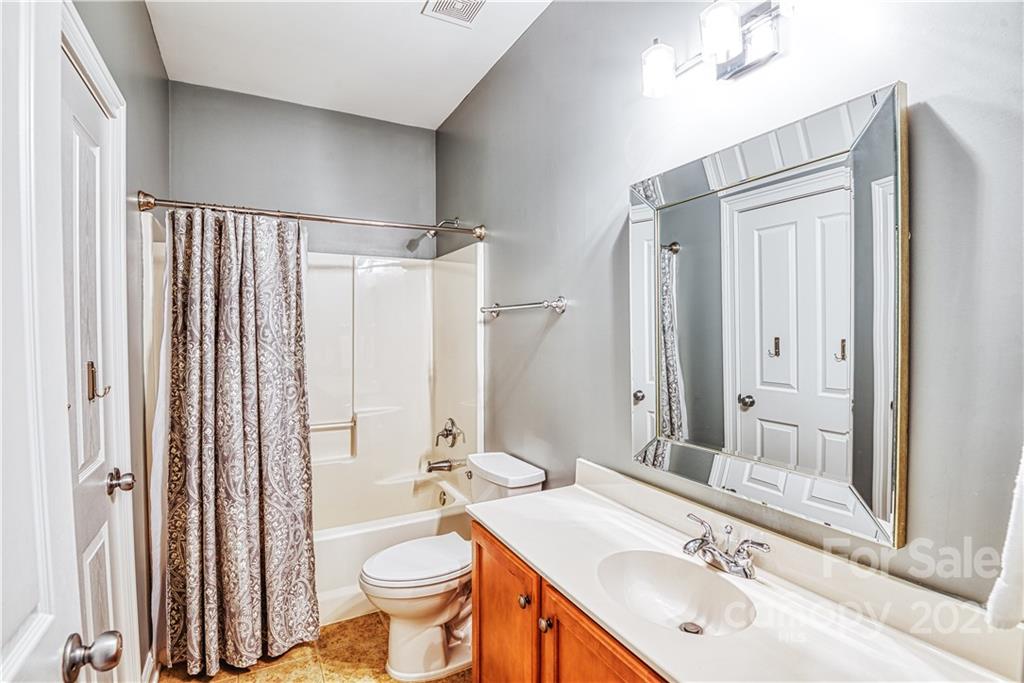 1183 Springmaid Avenue Fort Mill, SC 29708 - Photo 12 of 31 a bathroom with a sink toilet mirror and shower