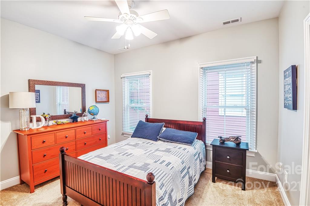1183 Springmaid Avenue Fort Mill, SC 29708 - Photo 13 of 31 a bedroom with a bed and a dresser