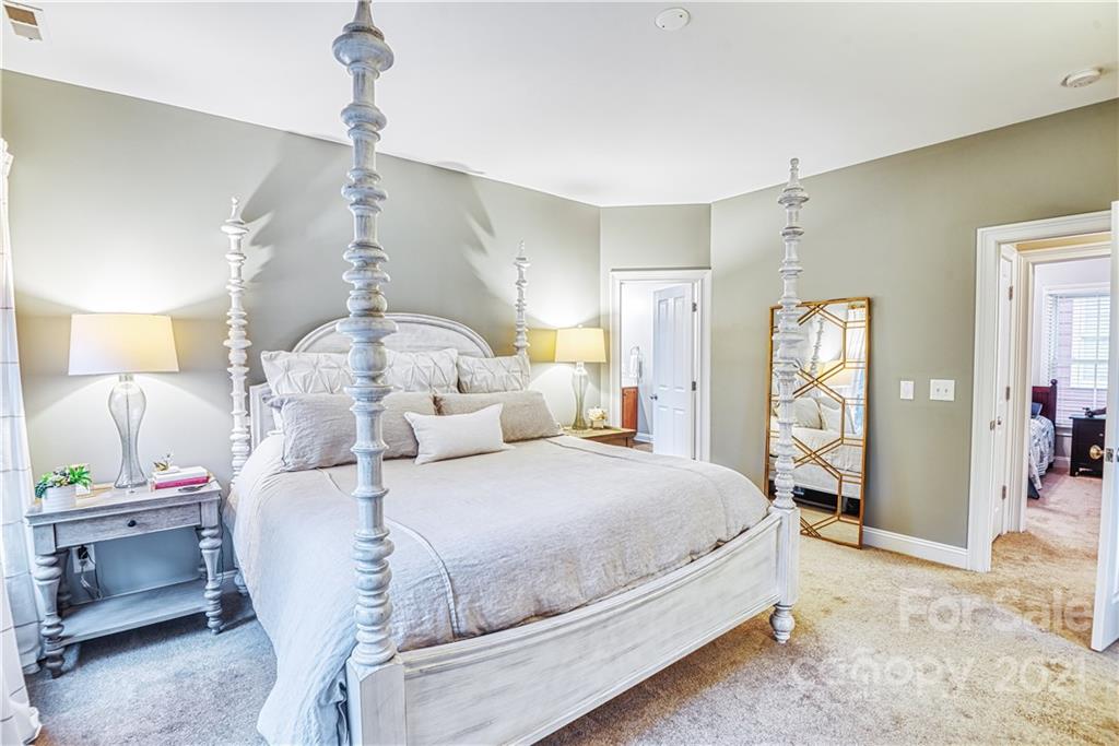 1183 Springmaid Avenue Fort Mill, SC 29708 - Photo 15 of 31 a bedroom with a bed and a chandelier