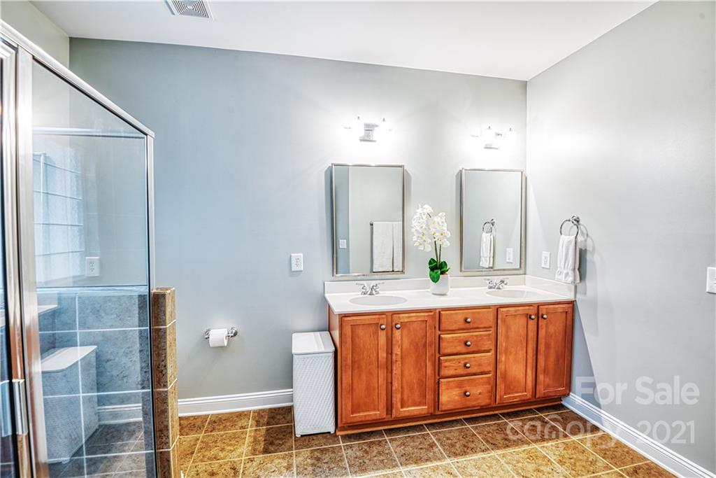 1183 Springmaid Avenue Fort Mill, SC 29708 - Photo 16 of 31 a spacious bathroom with a granite countertop sink and a mirror