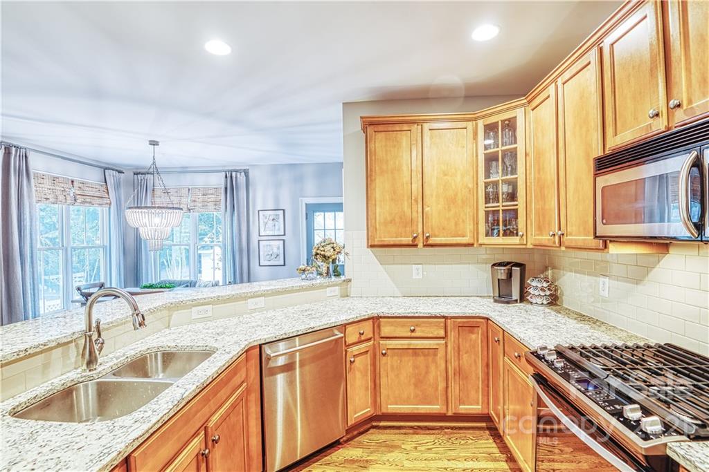 1183 Springmaid Avenue Fort Mill, SC 29708 - Photo 4 of 31 a kitchen with granite countertop a sink and a counter top space