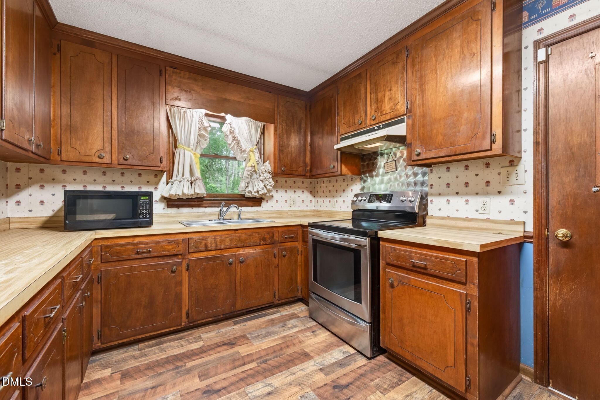 350 Grantham School Road Goldsboro, NC 27530 - Photo 10 of 49 a kitchen with stainless steel appliances granite countertop wooden cabinets stove top oven and sink
