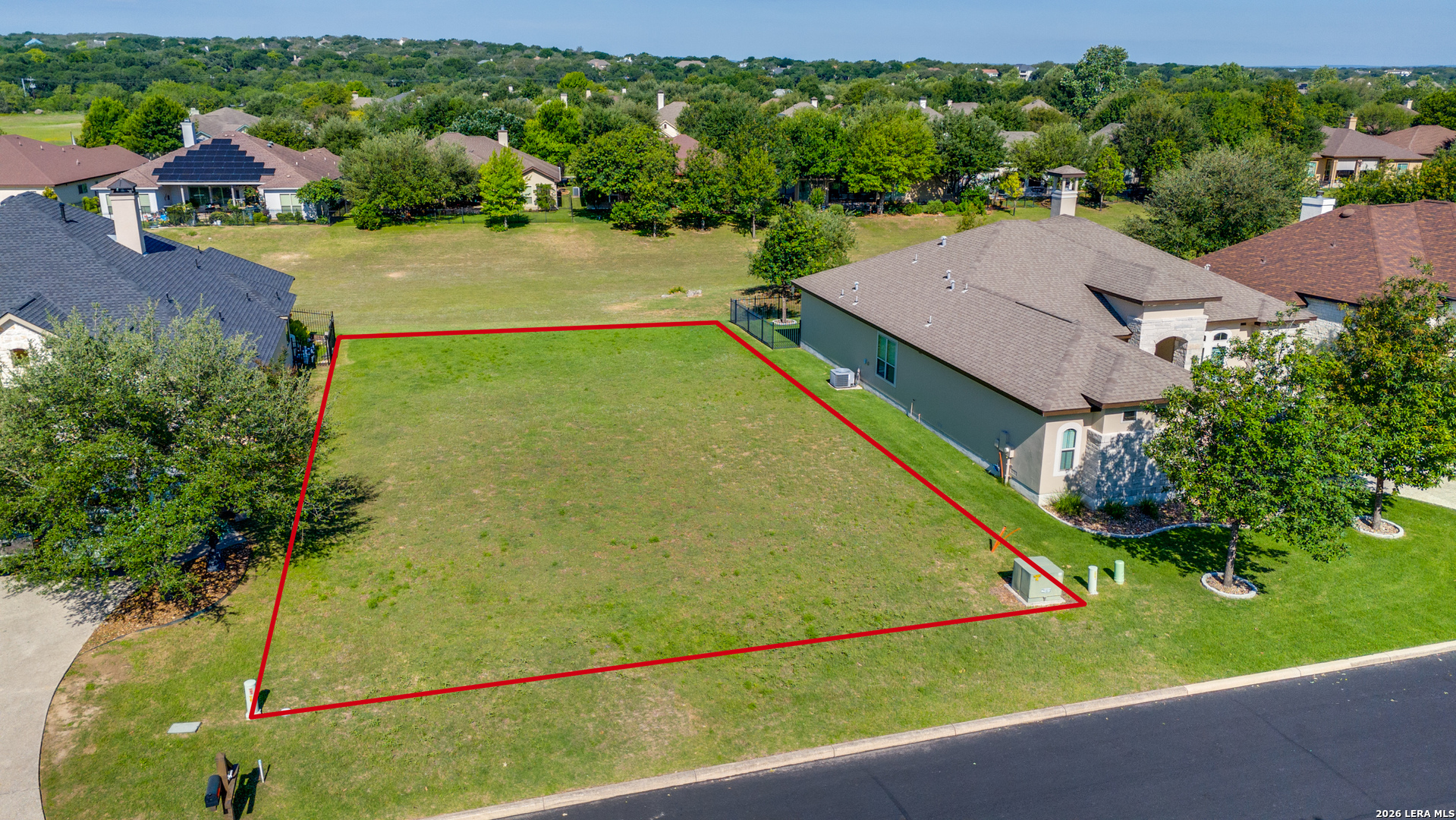 an aerial view of residential houses with yard