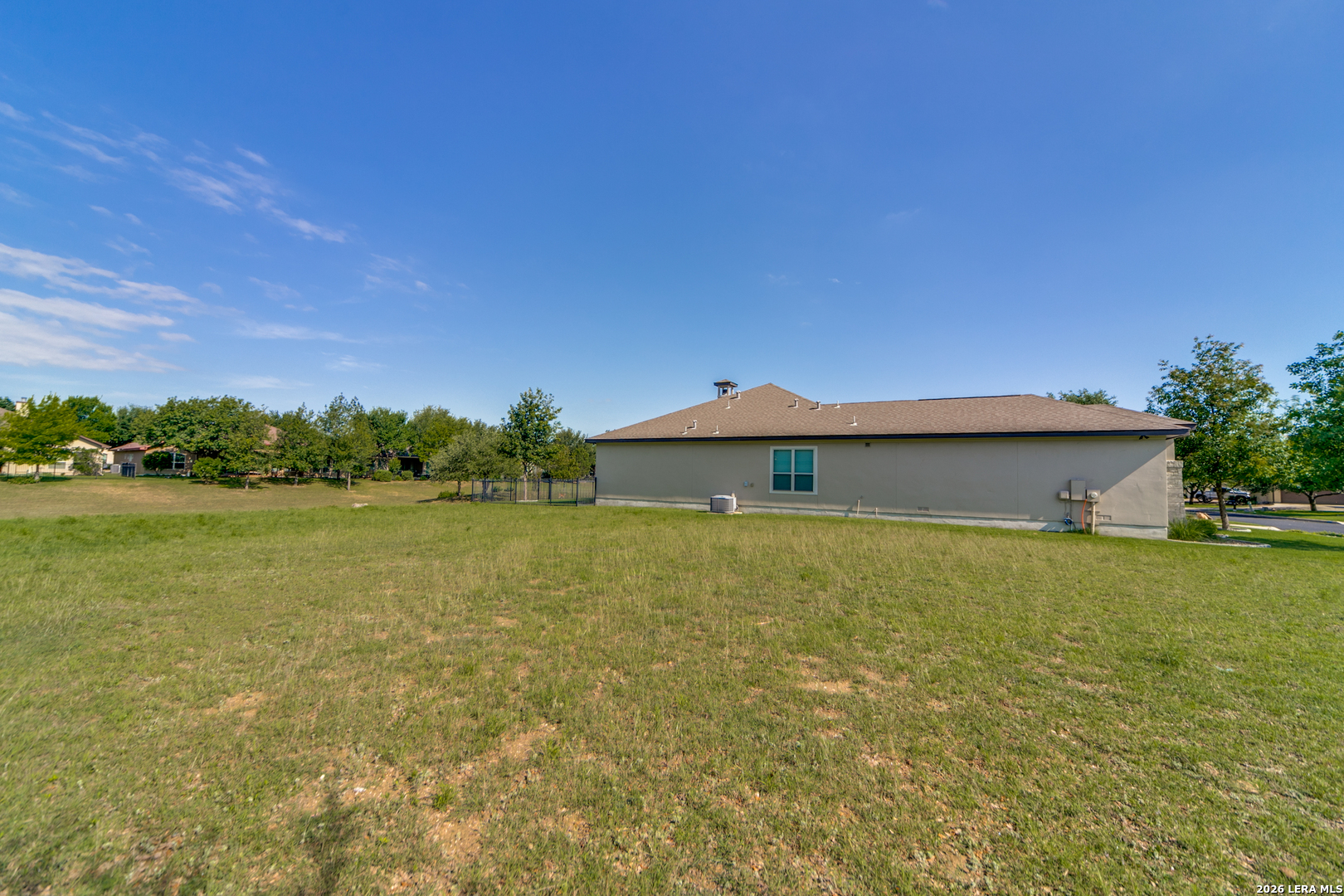 30015 Cibolo Path Fair Oaks Ranch, TX 78015 - Photo 5 of 11 a view of a house with a yard and a large tree