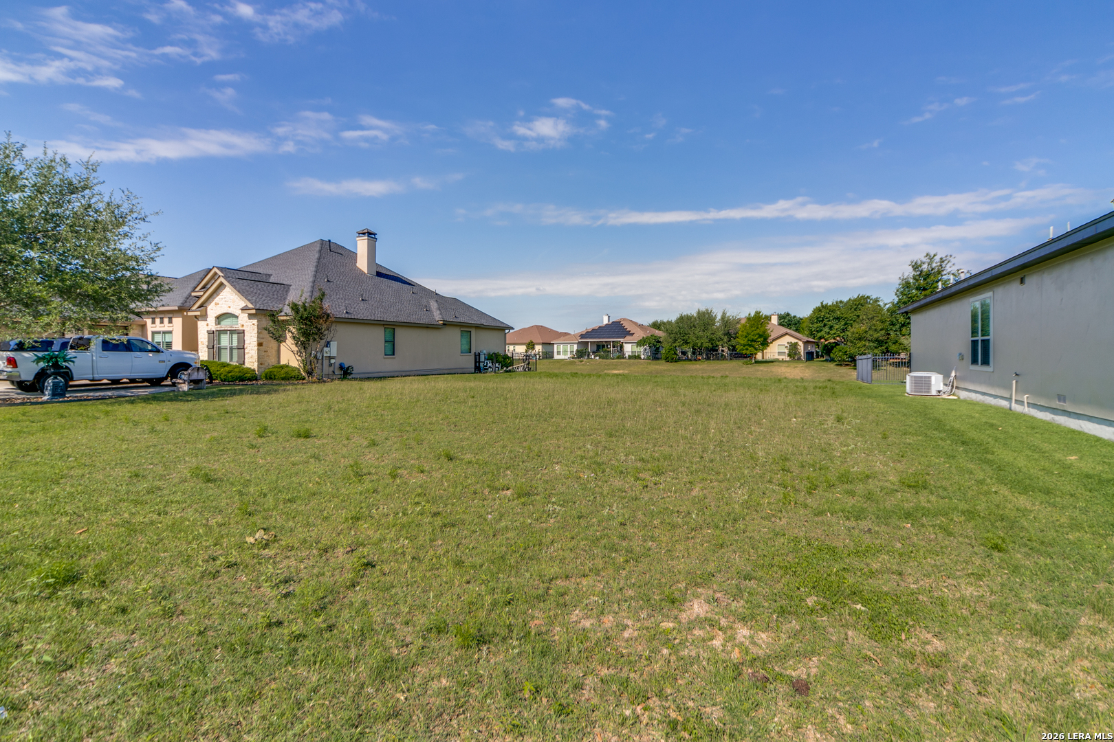 30015 Cibolo Path Fair Oaks Ranch, TX 78015 - Photo 10 of 11 a view of a big yard with an tree and fence