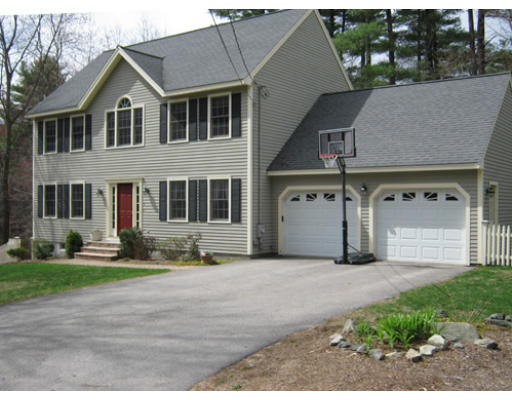 3 July Road Sudbury, MA 01776 - Photo 1 of 1 a front view of a house with a garden and trees