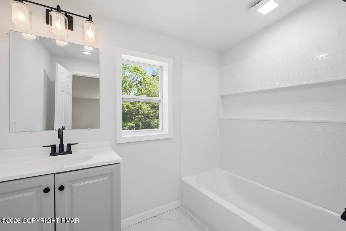 155 Blooming Grove Road Hawley, PA 18428 - Photo 34 of 41 a white bath tub sitting next to a white sink