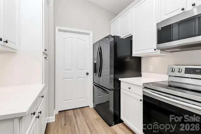 a kitchen with a refrigerator and a sink