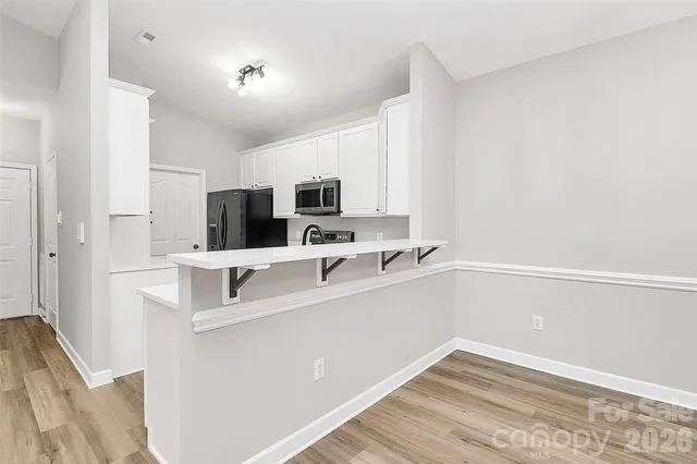 a spacious bathroom with a tub sink and mirror