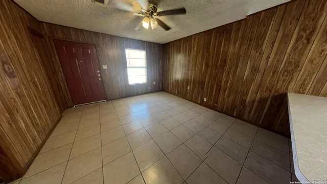 a view of a livingroom with a ceiling fan and window