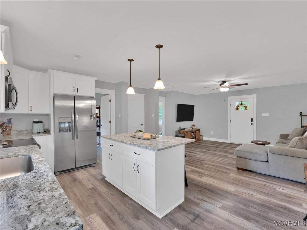 5440 New Line Road Gum Spring, VA 23065 - Photo 11 of 28 a open kitchen with stainless steel appliances granite countertop a stove refrigerator and cabinets