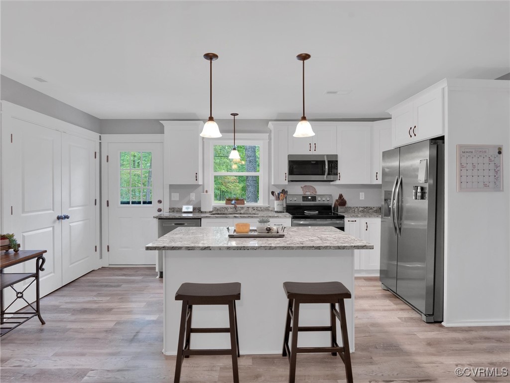 5440 New Line Road Gum Spring, VA 23065 - Photo 8 of 28 a kitchen with stainless steel appliances a stove a refrigerator and a wooden floor
