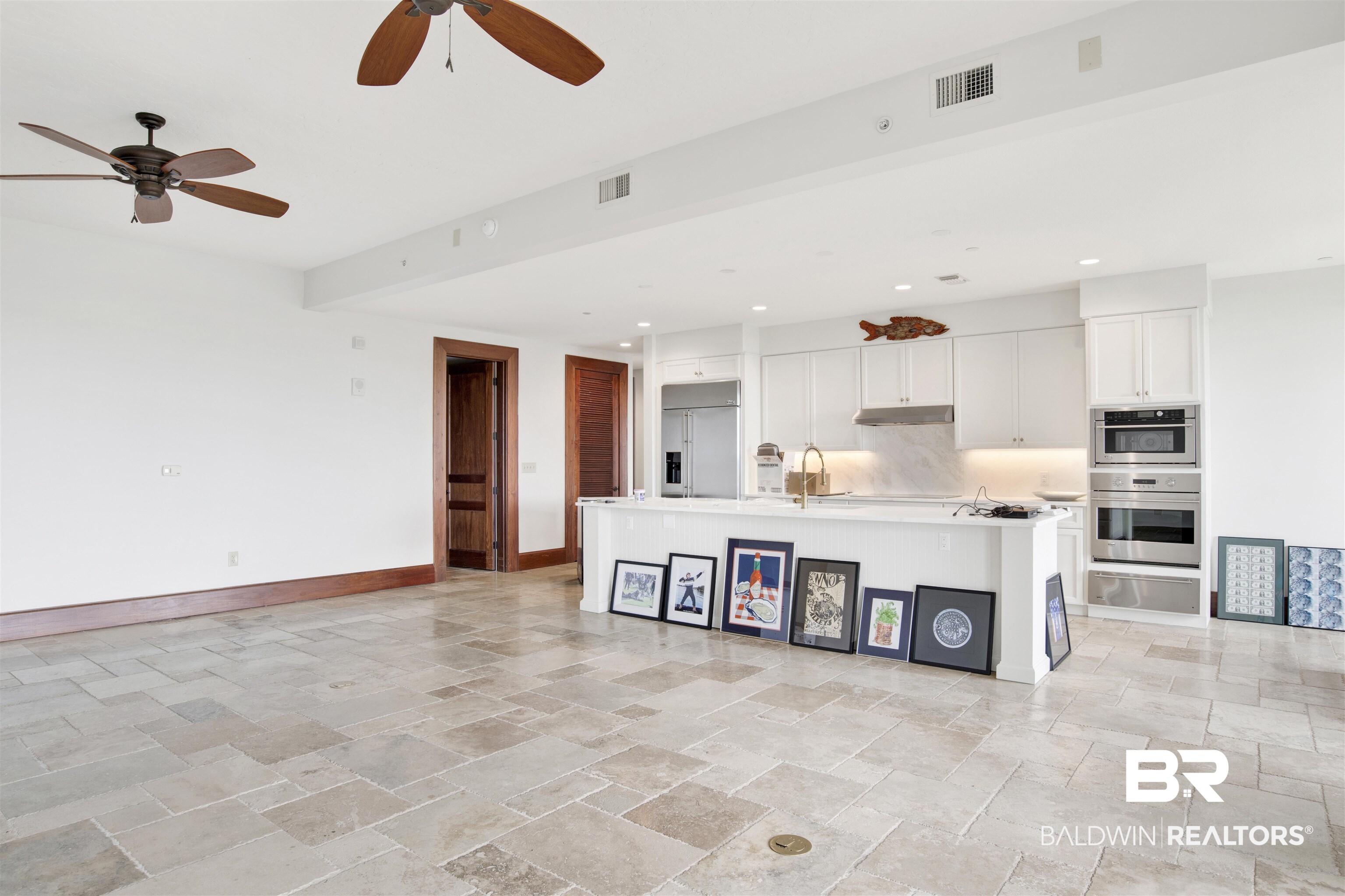 18269 Colony Drive, Unit 601 Fairhope, AL 36532 - Photo 2 of 47 Kitchen with white cabinetry, ceiling fan, stainless steel appliances, and light tile patterned floors