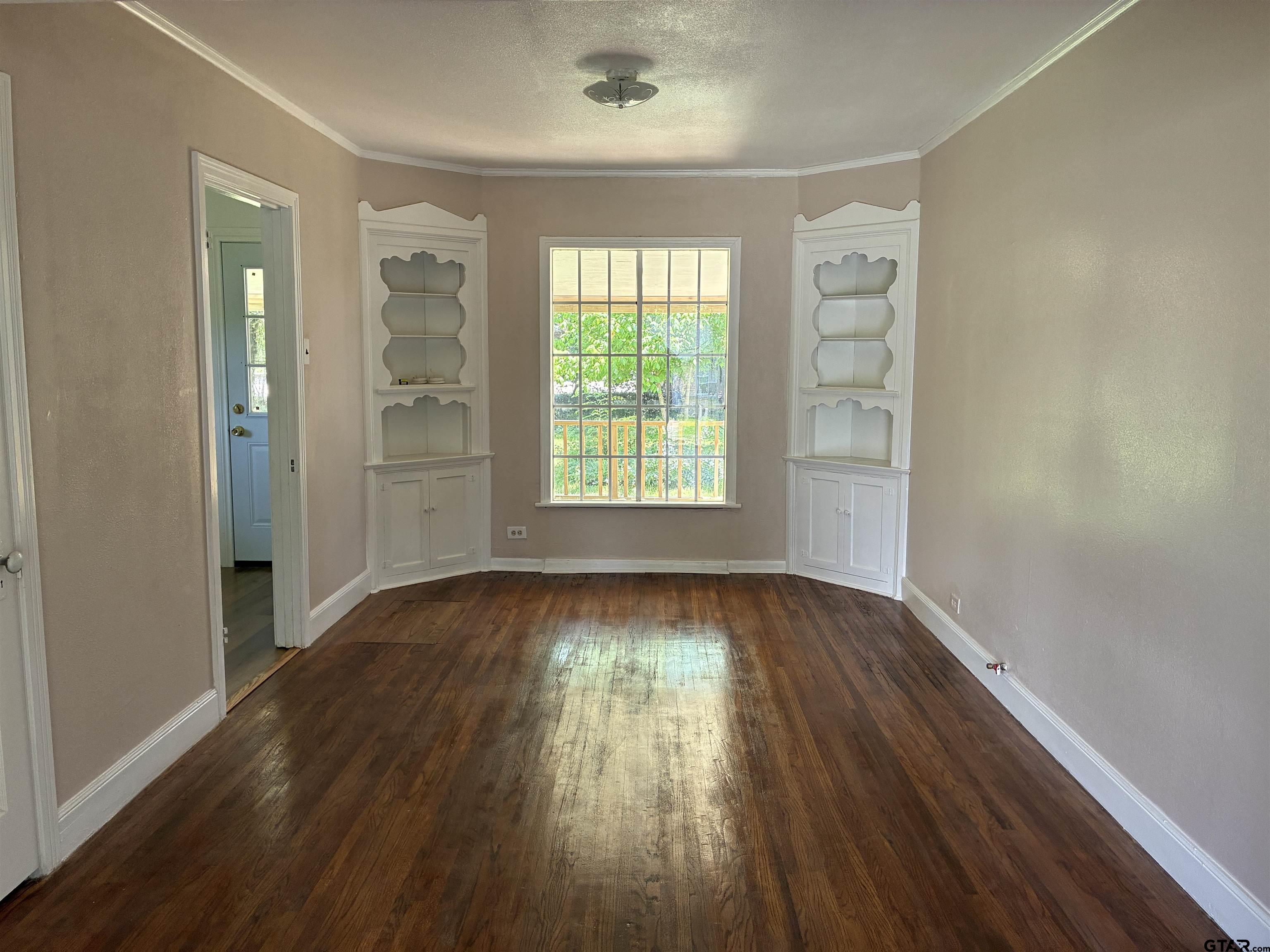 811 West 5th Street Tyler, TX 75701 - Photo 6 of 26 a view of an empty room with wooden floor and a window