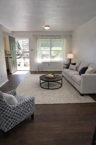 a living room with furniture window and wooden floor
