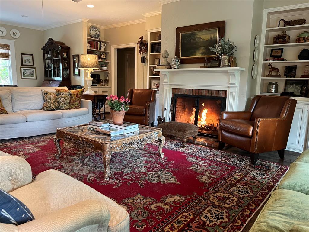 10200 North County Road Frisco, TX 75033 - Photo 15 of 25 a living room with furniture a flat screen tv and a fireplace