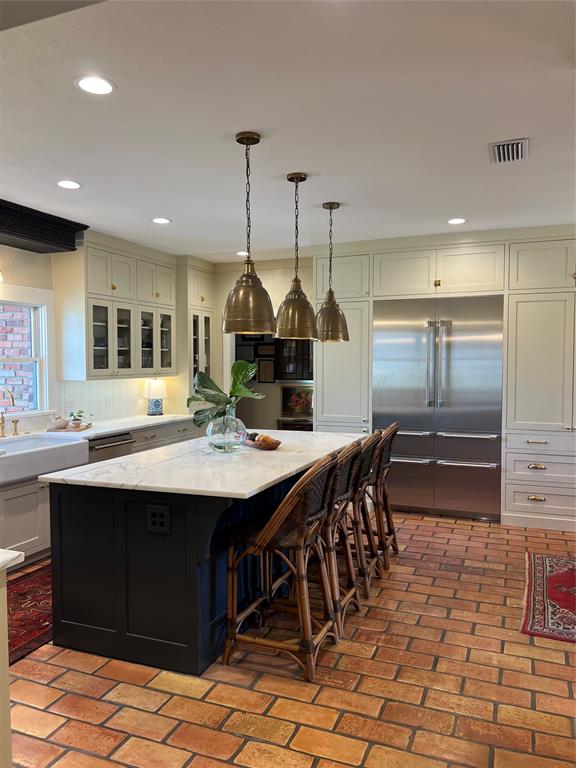 10200 North County Road Frisco, TX 75033 - Photo 6 of 25 a kitchen with kitchen island a sink table and chairs