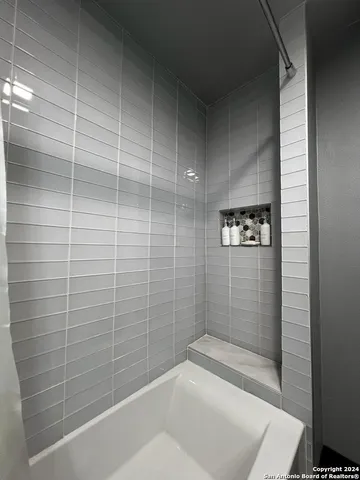 a bathroom with a toilet a sink and a mirror