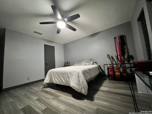 a bedroom with a bed and wooden floor