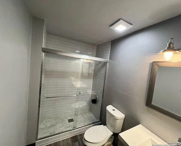 a bedroom with furniture and a wooden floor