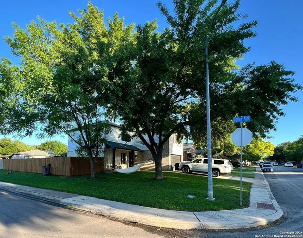a front view of a house with a yard and a garage