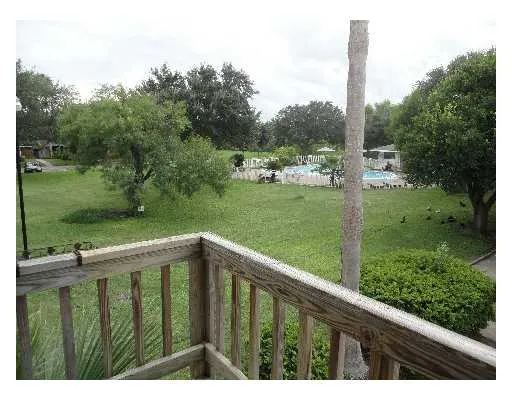 a view of a wooden deck with a yard