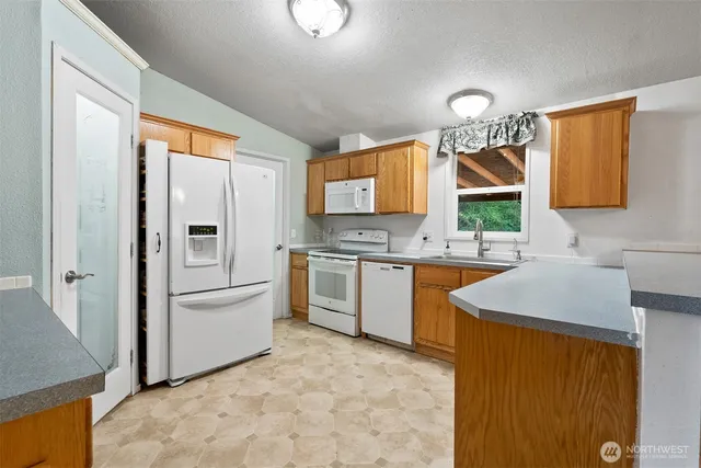 a kitchen with a sink cabinets and window