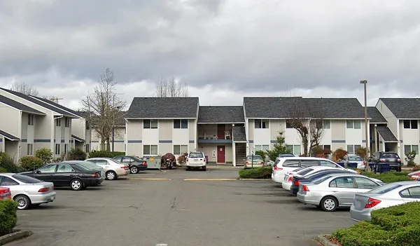 a view of a cars park in front of a building